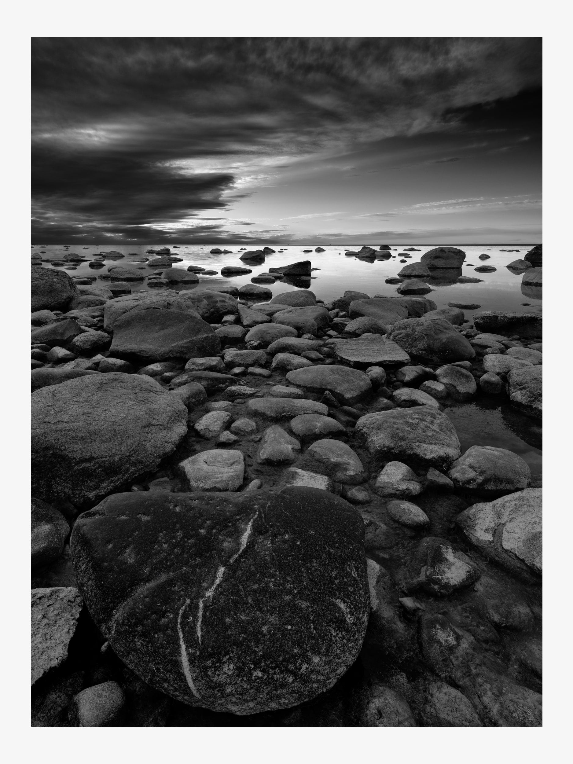 Black and White Seascape with Rocks and Dramatic Sky