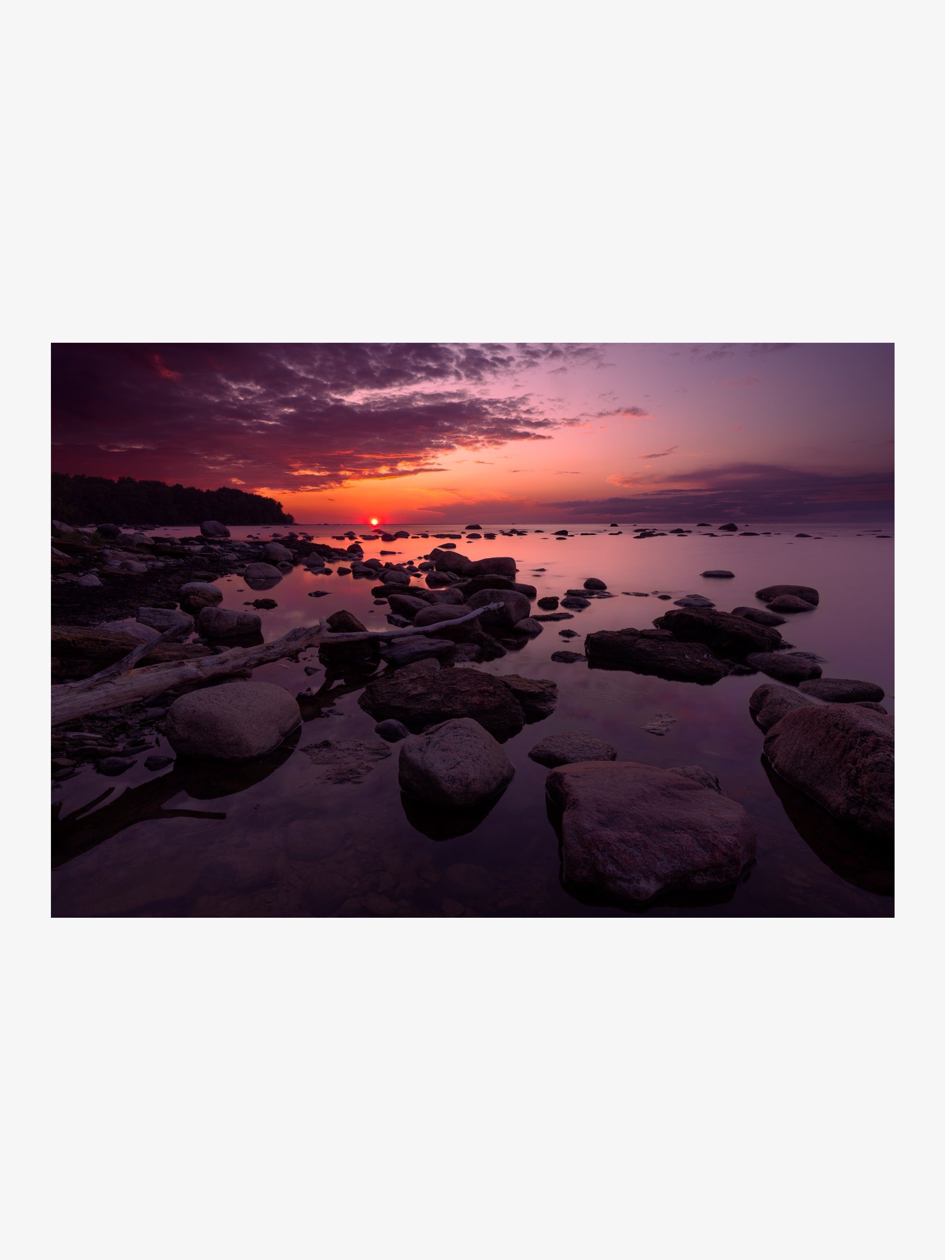 Sunset by the Sea with Rocks and Purple Sky