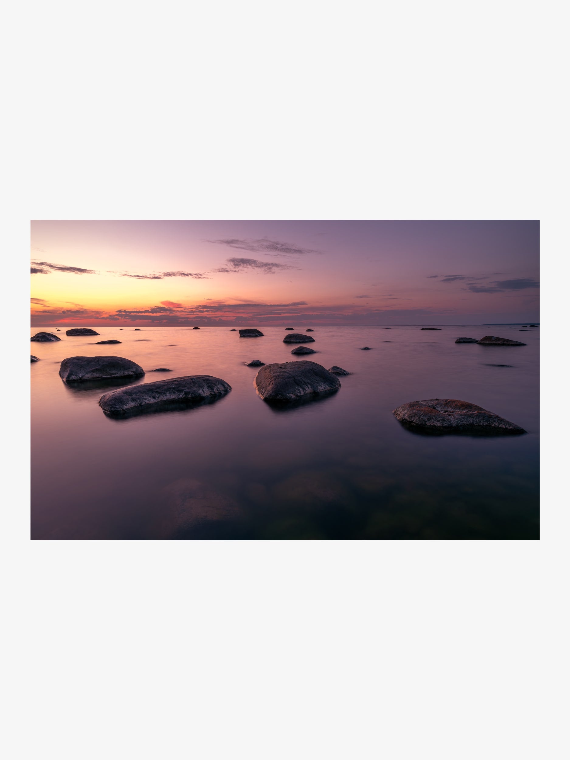 Rocks in the Sea at Sunset with Pink and Purple Sky
