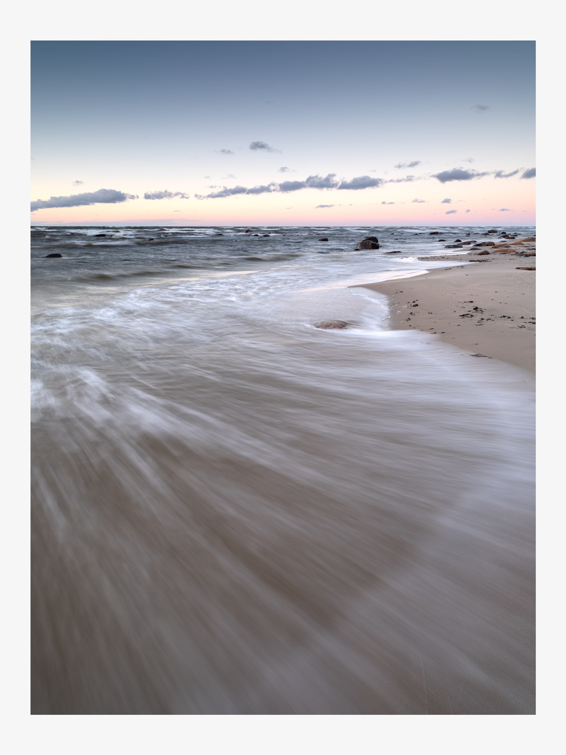 Sea Waves on a Sandy Shore in Soft Evening Light
