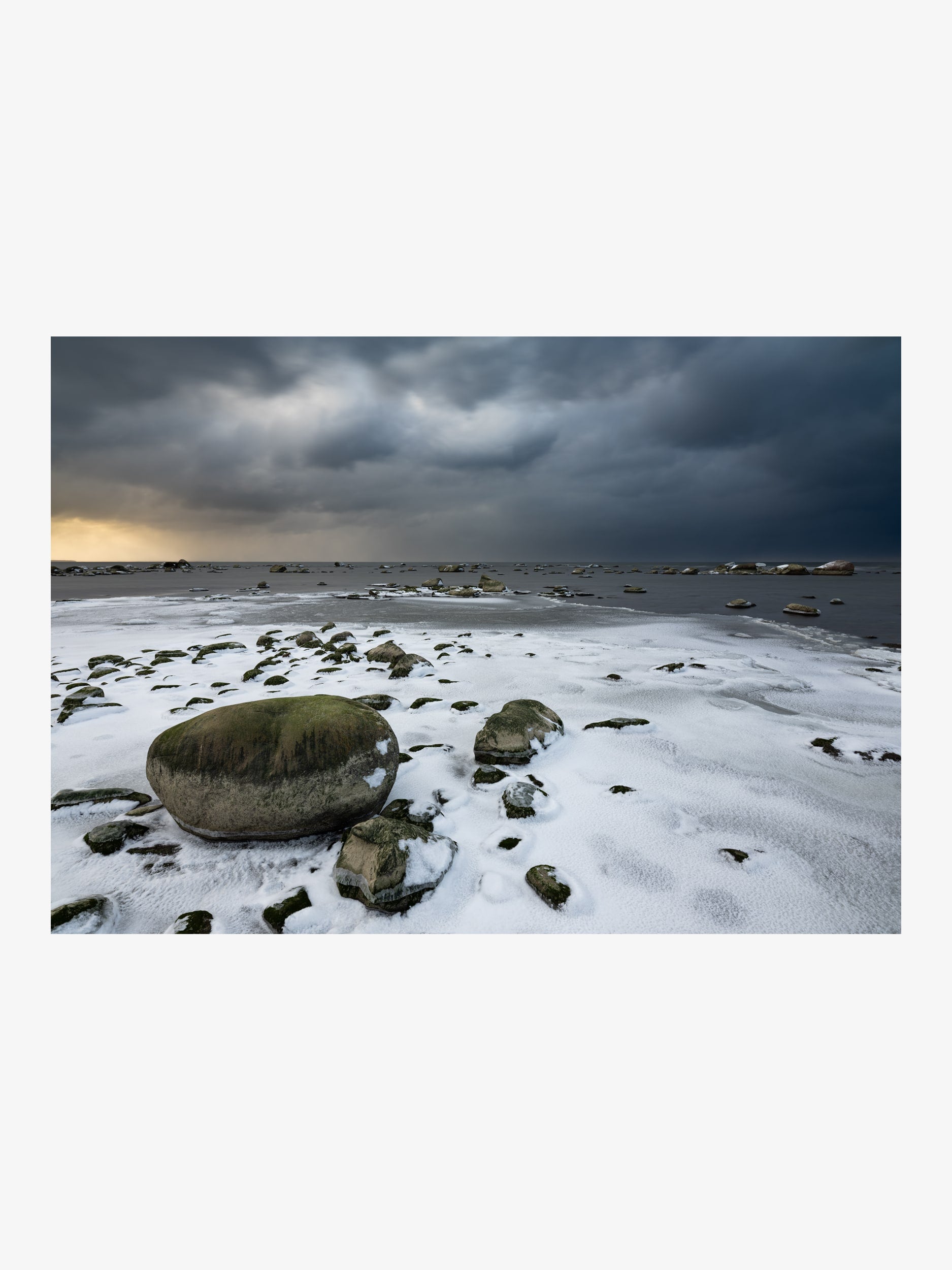 Rocks by the Winter Sea under Storm Clouds