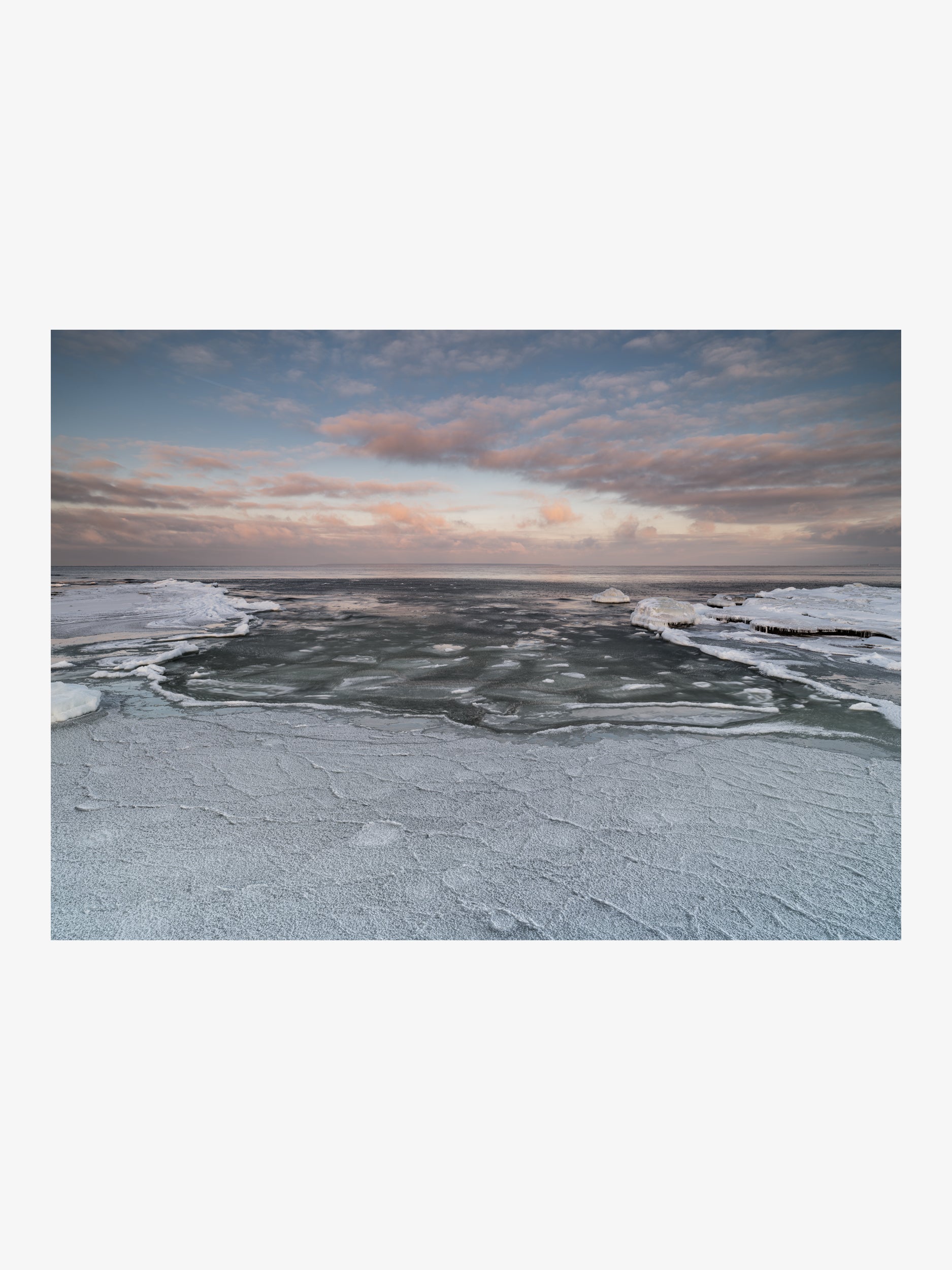Frozen Seashore with Ice Formations and Cloudy Sky