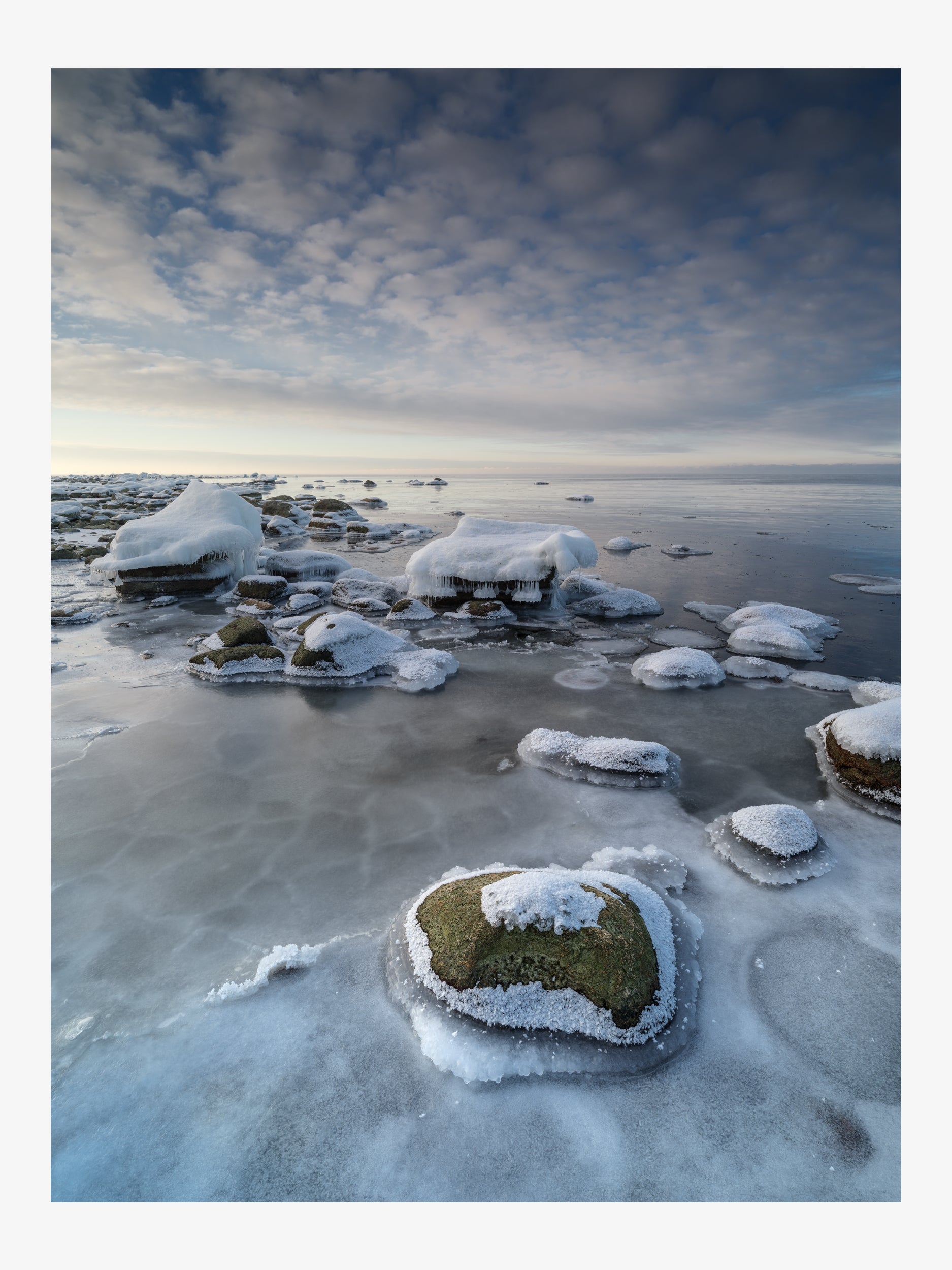 Frost-Covered Moss Rocks on a Frozen Shore