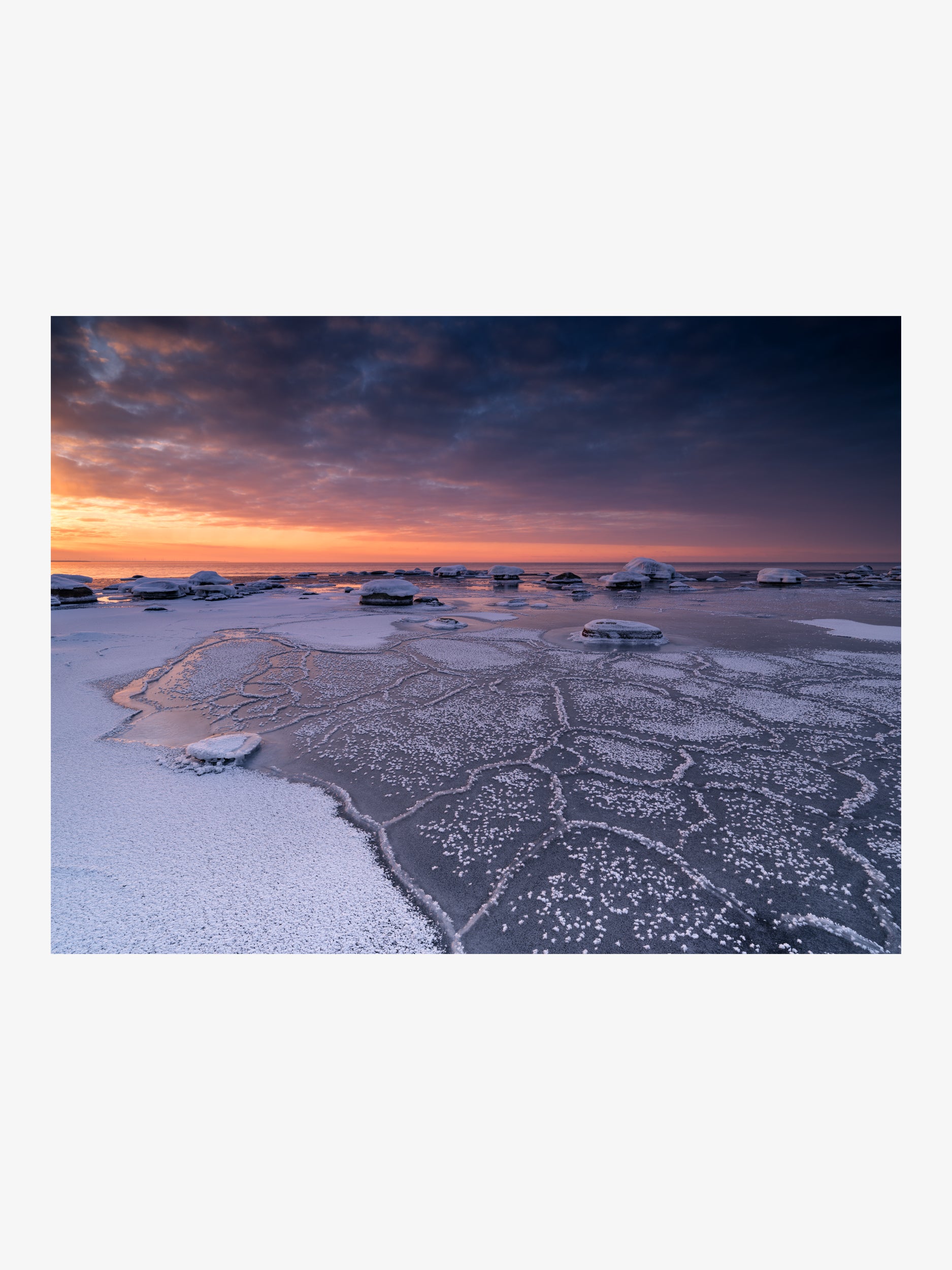 Frost Crystal Patterns on Ice Against a Fiery Sunset
