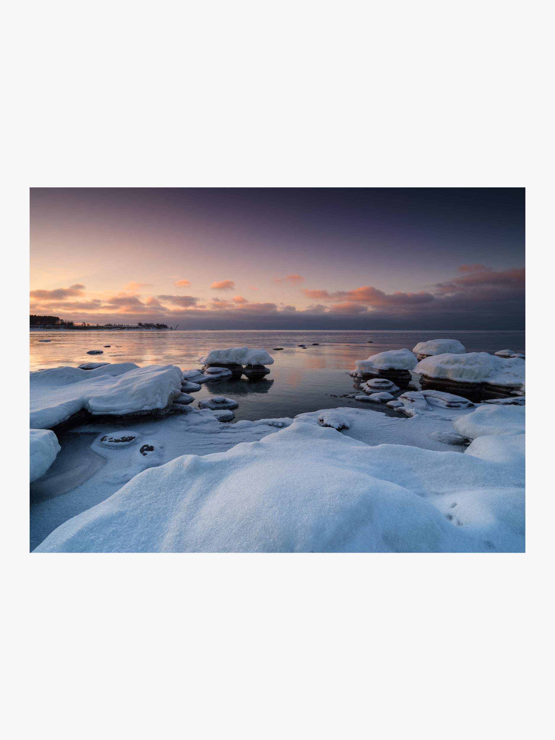 Calm Water Between Snow-Covered Rock Slabs at Sunset