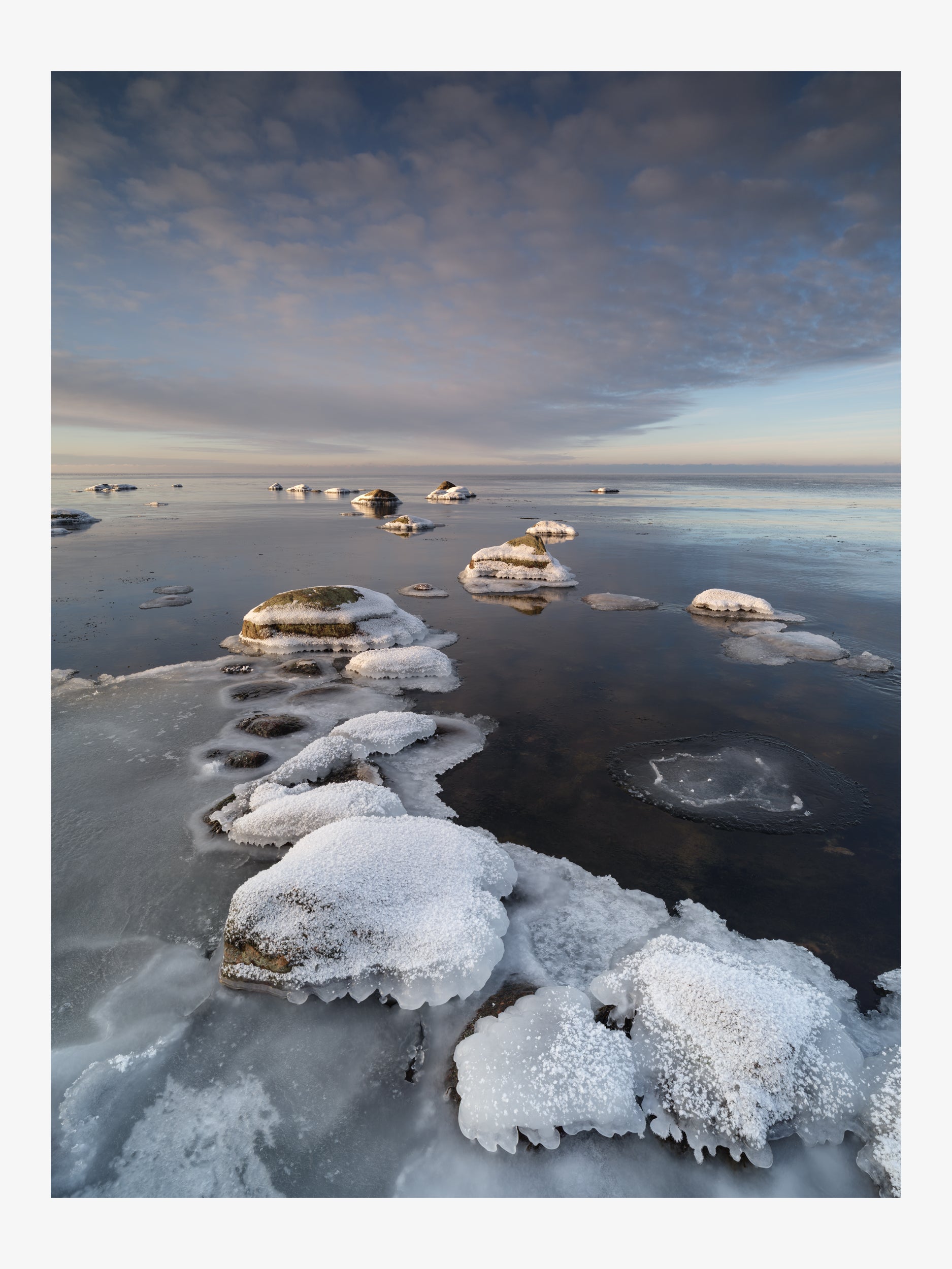 Ridge of Ice-Covered Rocks Leading Into the Sea